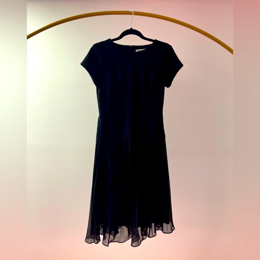 Classic black dress with pleated skirt